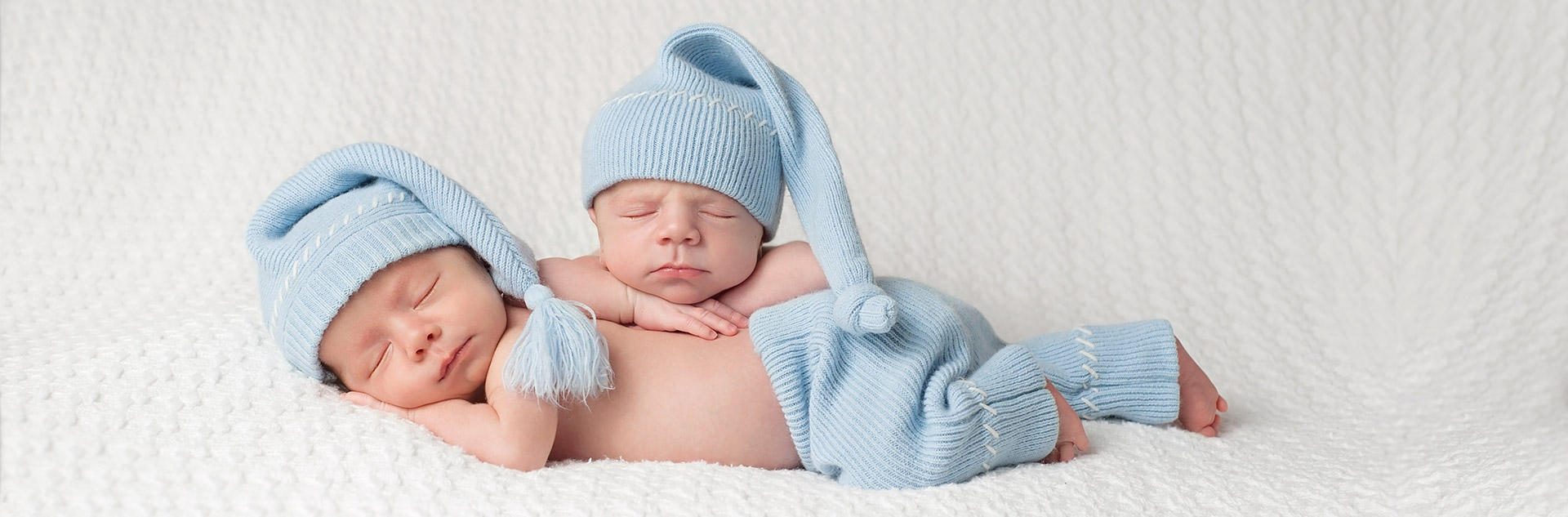 newborn twin boys potrait baby blue knit nightcaps and pants