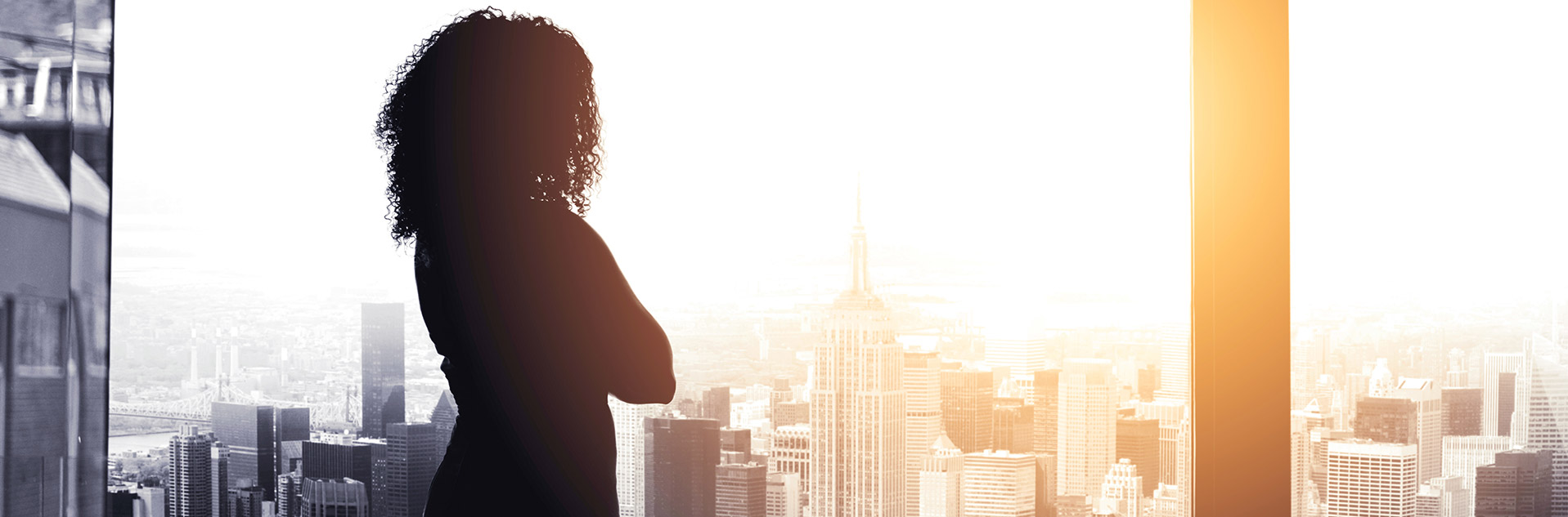 Business woman looking out window at New York City