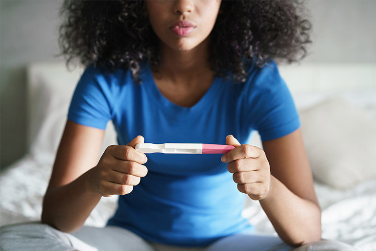 Woman with pregnancy test