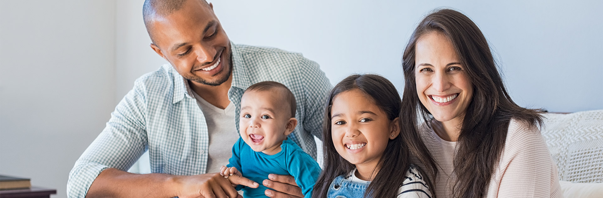 couple with two children, a young daughter and infant son