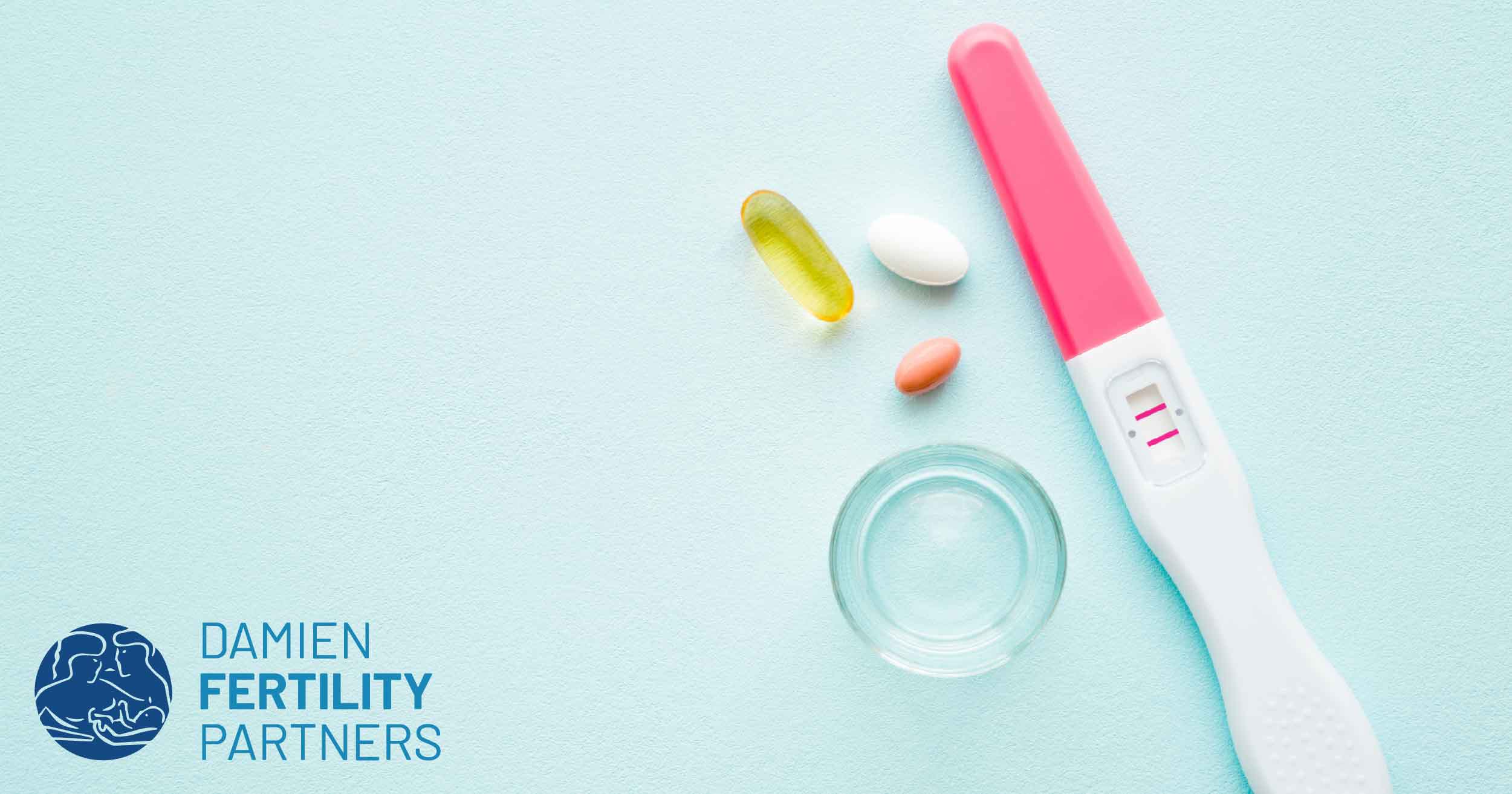 supplement pills, a glass of water and positive pregnancy test